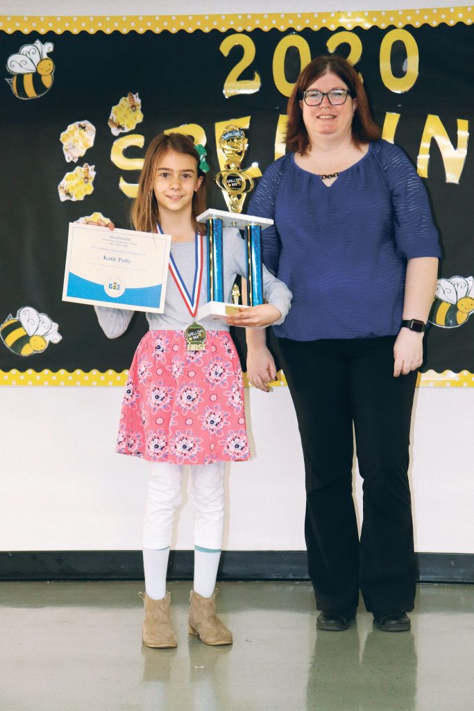 Katie Petty holds a trophy and a certificate after the Yokota West Elementary School bee. | YOKOTA WEST ELEMENTARY SCHOOL